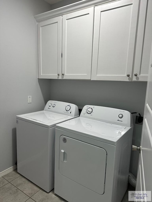 washroom featuring cabinet space, separate washer and dryer, baseboards, and light tile patterned floors