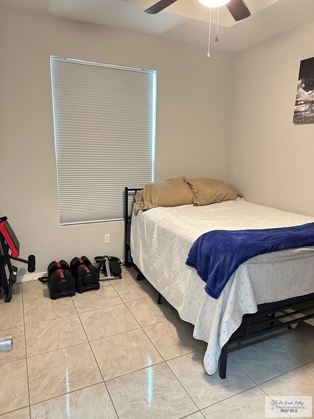 tiled bedroom with a ceiling fan