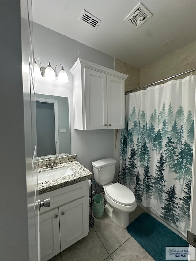 bathroom with toilet, tile patterned floors, visible vents, and vanity