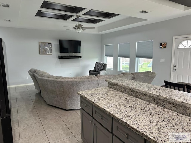 living room featuring visible vents, a ceiling fan, and a healthy amount of sunlight