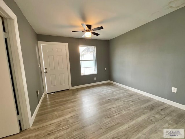 entrance foyer featuring wood finished floors, a ceiling fan, and baseboards