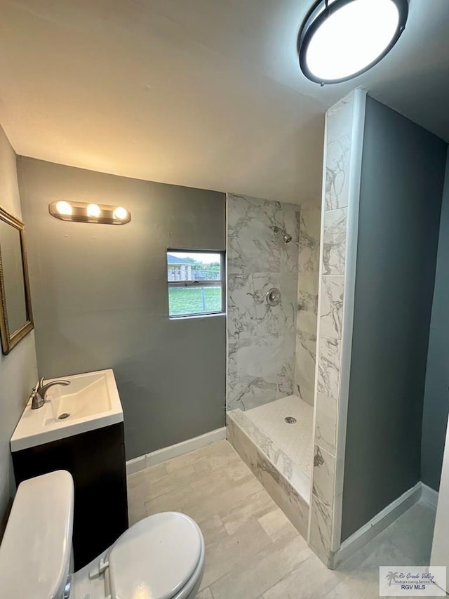 bathroom featuring walk in shower, toilet, and vanity