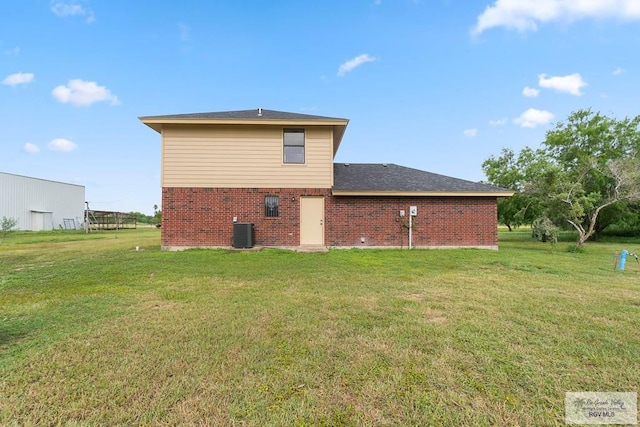 27859 Mile 3, La Feria, TX 78559 - back of property featuring cooling unit, a yard, and brick siding