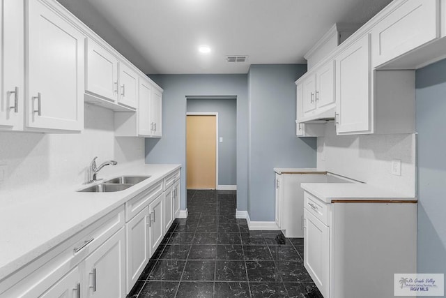 27859 Mile 3, La Feria, TX 78559 - kitchen featuring a sink, white cabinets, baseboards, light countertops, and recessed lighting