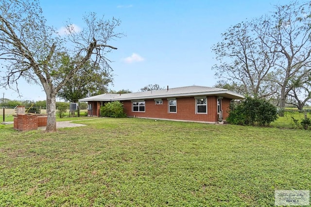 rear view of property with a lawn