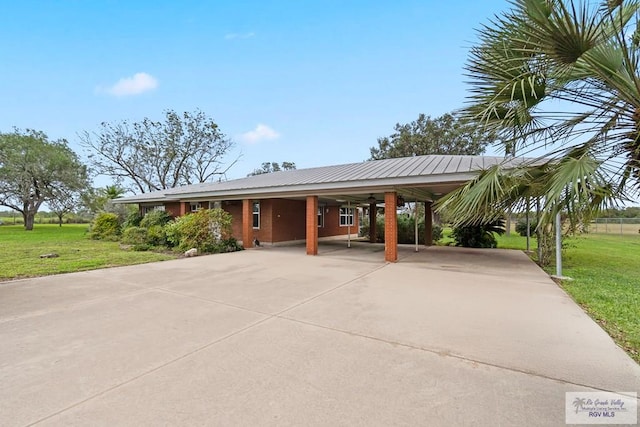 exterior space with a carport and a front lawn