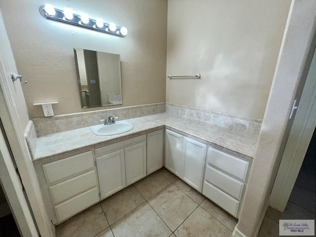 bathroom with tile patterned floors and vanity