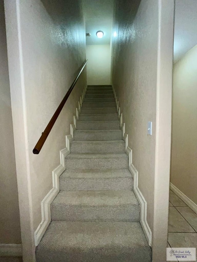 staircase with tile patterned floors