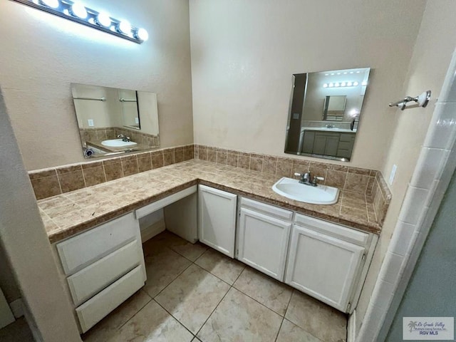 bathroom featuring vanity, tasteful backsplash, and tile patterned floors