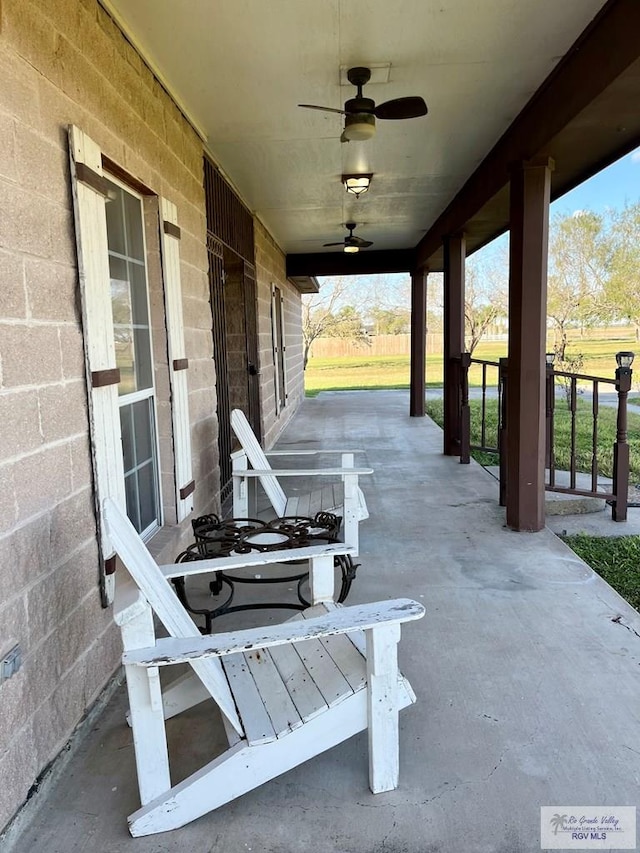 view of patio featuring ceiling fan and a porch