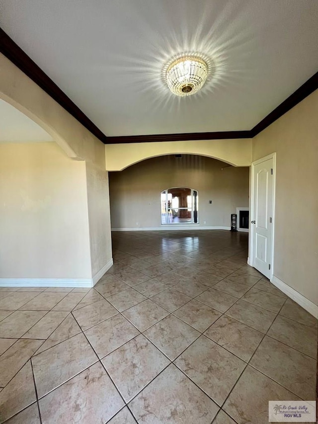 tiled spare room with ornamental molding