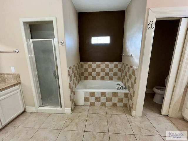 full bathroom with tile patterned floors, vanity, separate shower and tub, and toilet