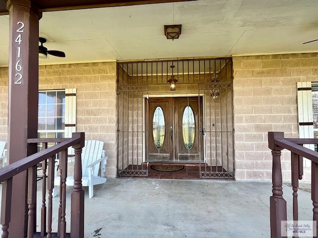 view of exterior entry featuring covered porch