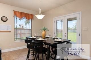 dining area with tile patterned flooring and french doors