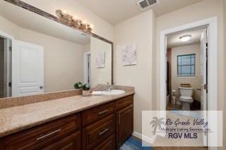 bathroom with vanity and toilet