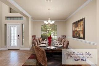 dining room featuring tile patterned floors, ornamental molding, and a notable chandelier