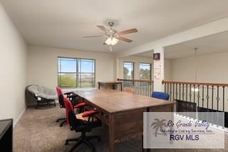 carpeted office featuring ceiling fan