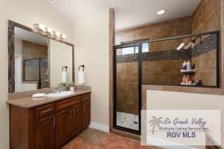 bathroom featuring vanity and an enclosed shower