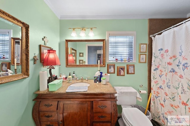 bathroom with crown molding, plenty of natural light, and toilet