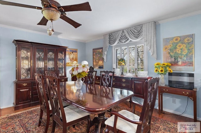 dining room featuring dark hardwood / wood-style floors, ceiling fan, and crown molding