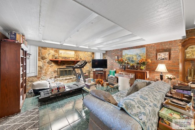 living room with a stone fireplace and brick wall