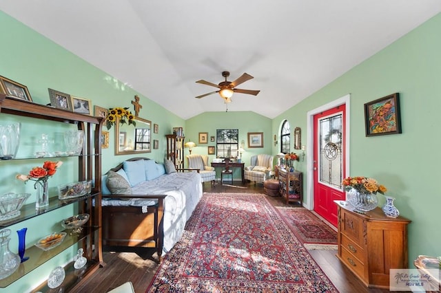 living room with ceiling fan, dark hardwood / wood-style floors, and lofted ceiling