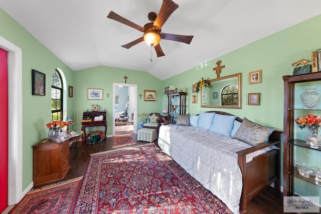 living room with dark wood-type flooring, ceiling fan, and lofted ceiling