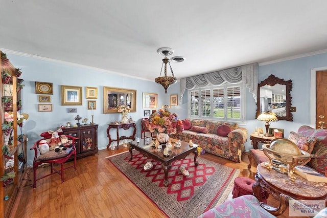 living room with light hardwood / wood-style flooring and ornamental molding