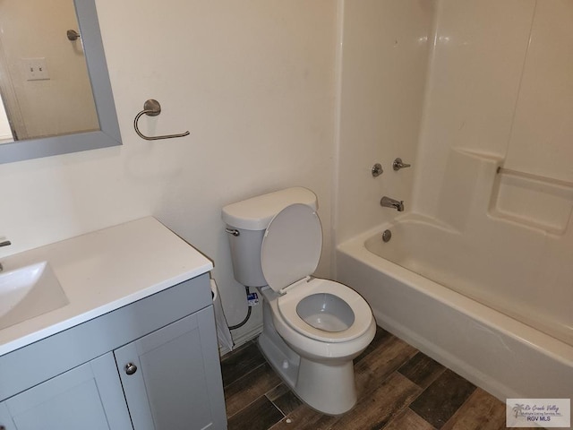 full bathroom with hardwood / wood-style floors, vanity, bathtub / shower combination, and toilet