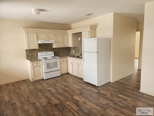 kitchen featuring backsplash, dark hardwood / wood-style flooring, and white appliances