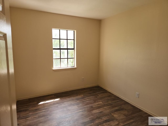 spare room with dark hardwood / wood-style floors