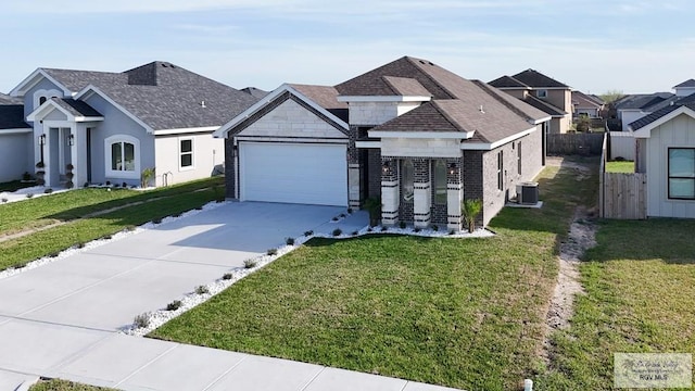 8801 Swan Lake Dr # 24, Harlingen, TX 78552 - view of front of property with driveway, stone siding, central AC, and a front yard