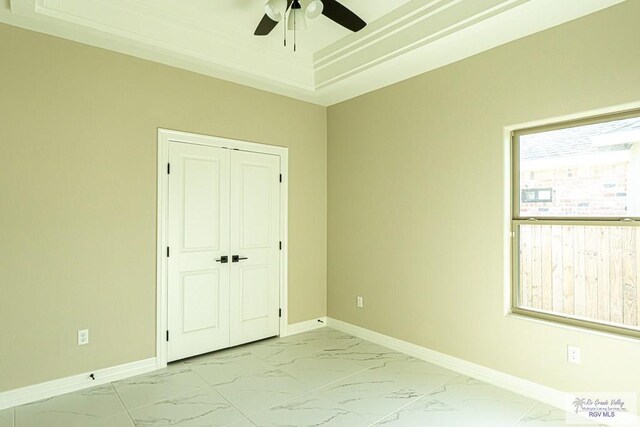 8801 Swan Lake Dr # 24, Harlingen, TX 78552 - unfurnished bedroom with marble finish floor, baseboards, a raised ceiling, and a closet