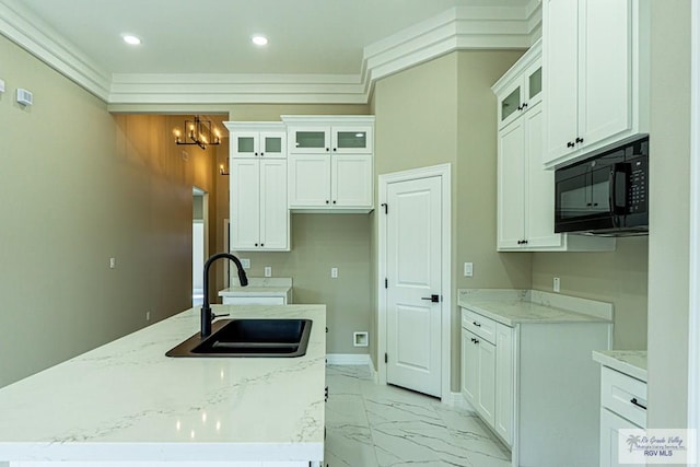 8801 Swan Lake Dr # 24, Harlingen, TX 78552 - kitchen with white cabinets, light stone countertops, marble finish floor, black microwave, and a sink