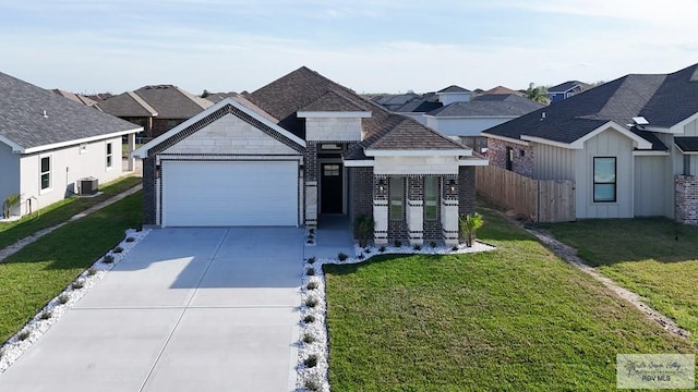 8801 Swan Lake Dr # 24, Harlingen, TX 78552 - view of front of home featuring driveway, an attached garage, fence, cooling unit, and a front lawn