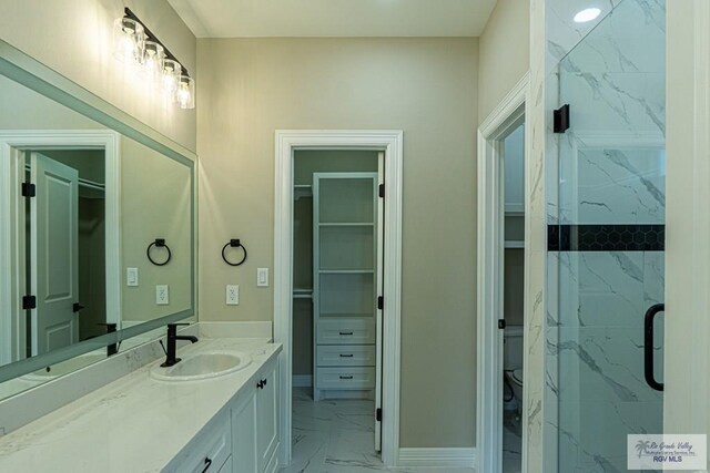 8801 Swan Lake Dr # 24, Harlingen, TX 78552 - full bathroom featuring toilet, marble finish floor, a walk in closet, and vanity