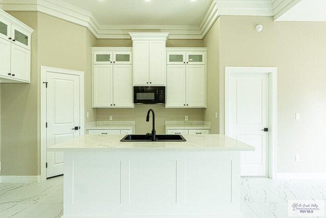 8801 Swan Lake Dr # 24, Harlingen, TX 78552 - kitchen with marble finish floor, crown molding, a sink, black microwave, and baseboards