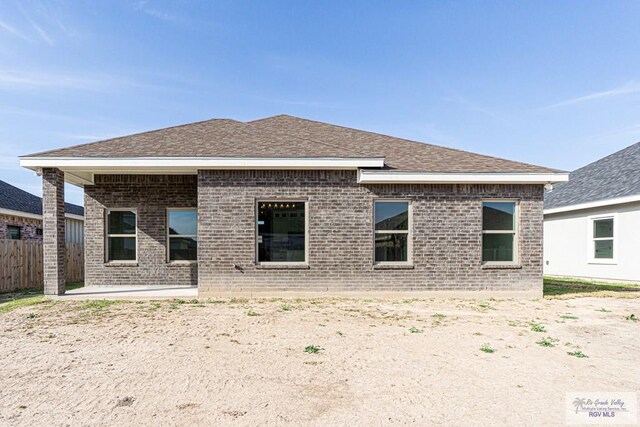 8801 Swan Lake Dr # 24, Harlingen, TX 78552 - back of property with a patio area, brick siding, a shingled roof, and fence