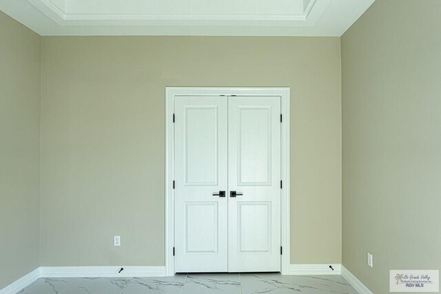 8801 Swan Lake Dr # 24, Harlingen, TX 78552 - unfurnished bedroom featuring marble finish floor, a closet, and baseboards