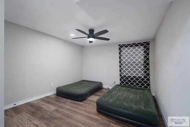 living area featuring wood-type flooring and ceiling fan