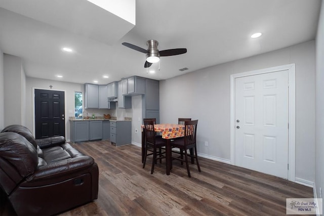 dining area featuring ceiling fan and dark wood-type flooring