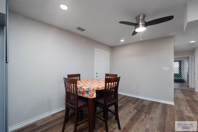 dining space with ceiling fan and dark hardwood / wood-style floors