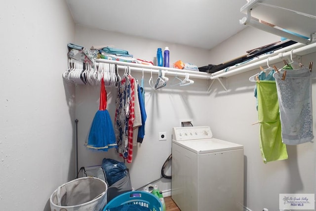 clothes washing area with washer / dryer and hardwood / wood-style floors