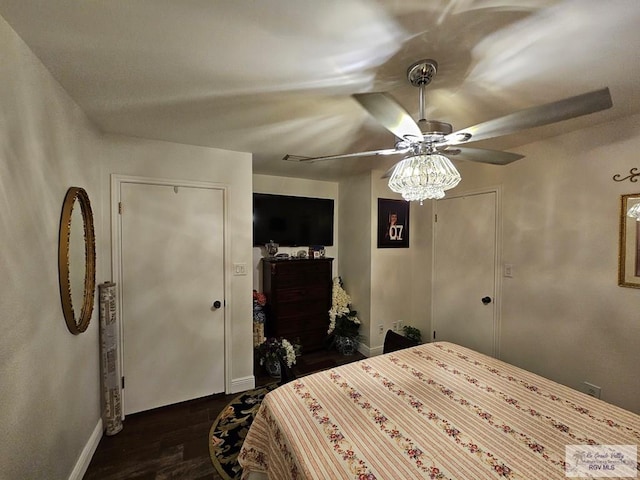 bedroom with ceiling fan and dark hardwood / wood-style floors