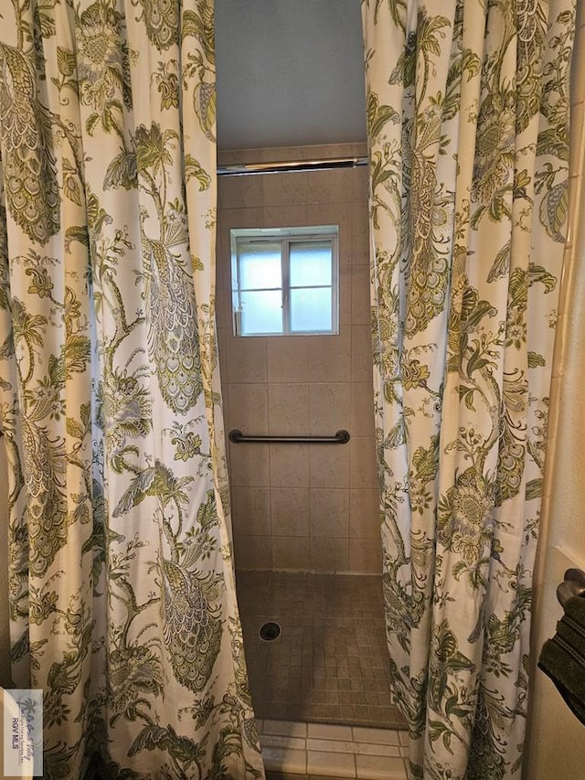 bathroom with tile patterned flooring and curtained shower