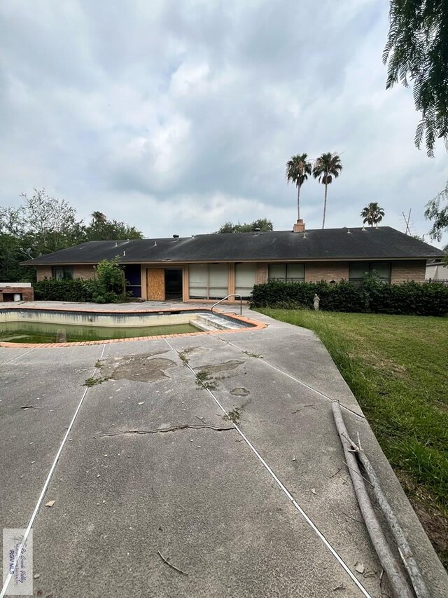 35 Alvarado Ave, Rancho Viejo, TX 78575 - single story home featuring uncovered parking, a front lawn, an outdoor pool, and a patio