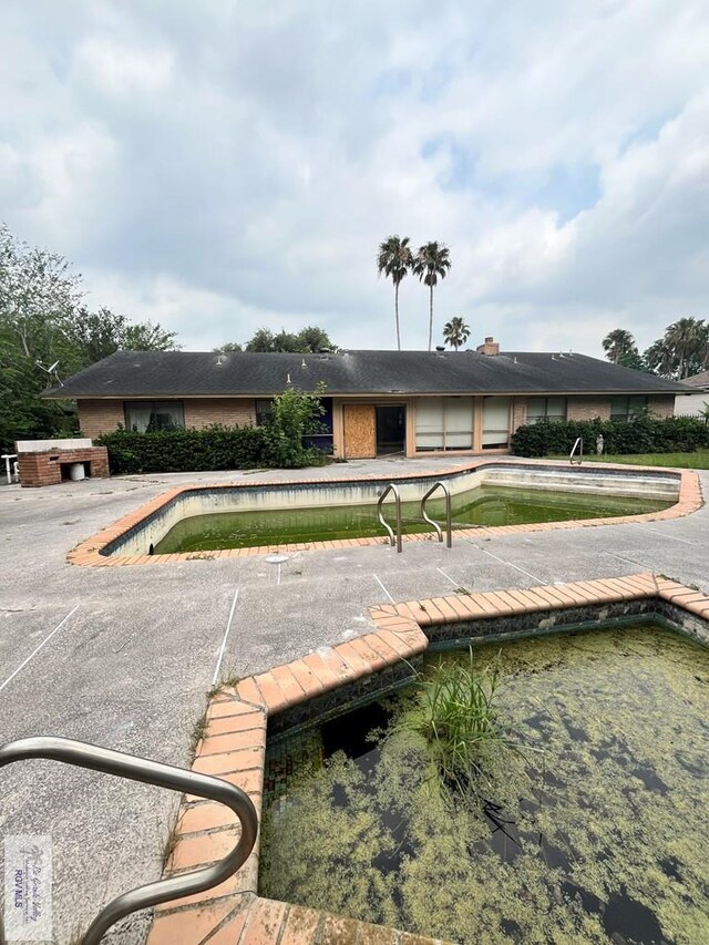 35 Alvarado Ave, Rancho Viejo, TX 78575 - dock area with an outdoor pool and a patio area