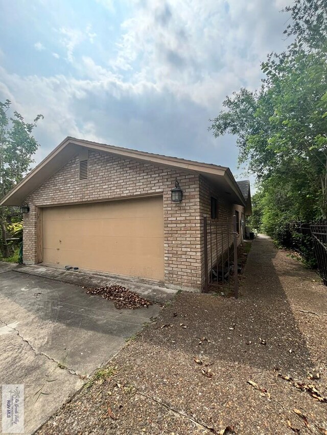 35 Alvarado Ave, Rancho Viejo, TX 78575 - view of property exterior with brick siding, concrete driveway, and an attached garage