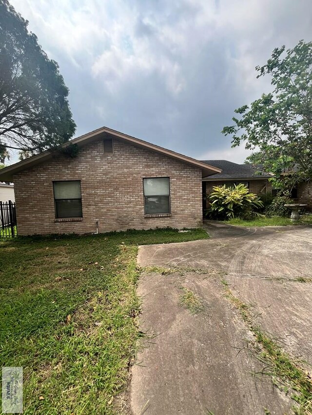 35 Alvarado Ave, Rancho Viejo, TX 78575 - view of side of home featuring brick siding