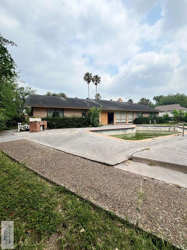 35 Alvarado Ave, Rancho Viejo, TX 78575 - ranch-style home featuring brick siding and a patio area